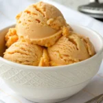 Three luscious scoops of homemade orange creamsicle ice cream
