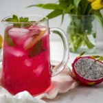 Close-up of dragon fruit lemonade drink with lemon slices and ice in a clear glass