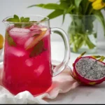 Close-up of dragon fruit lemonade drink with lemon slices and ice in a clear glass